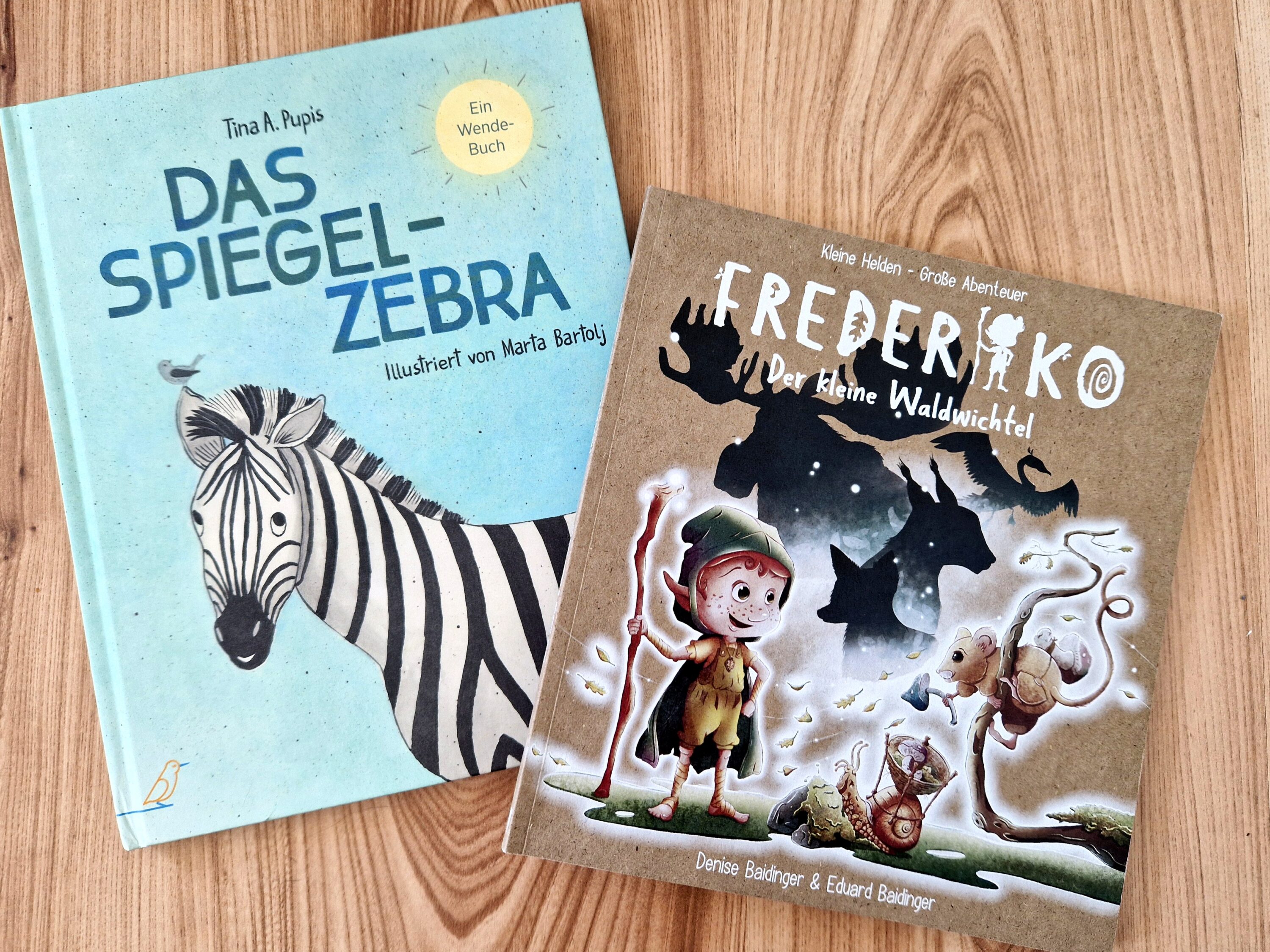 Die beiden Bilderbücher "Das Spiegel-Zebra" und "Frederiko - Der kleine Waldwichtel" liegen nebeneinander